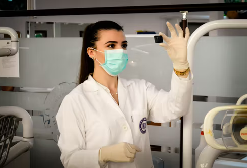 A female medical practitioner observing a specimen