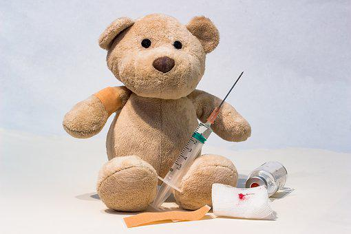 Syringe placed near a teddy bear