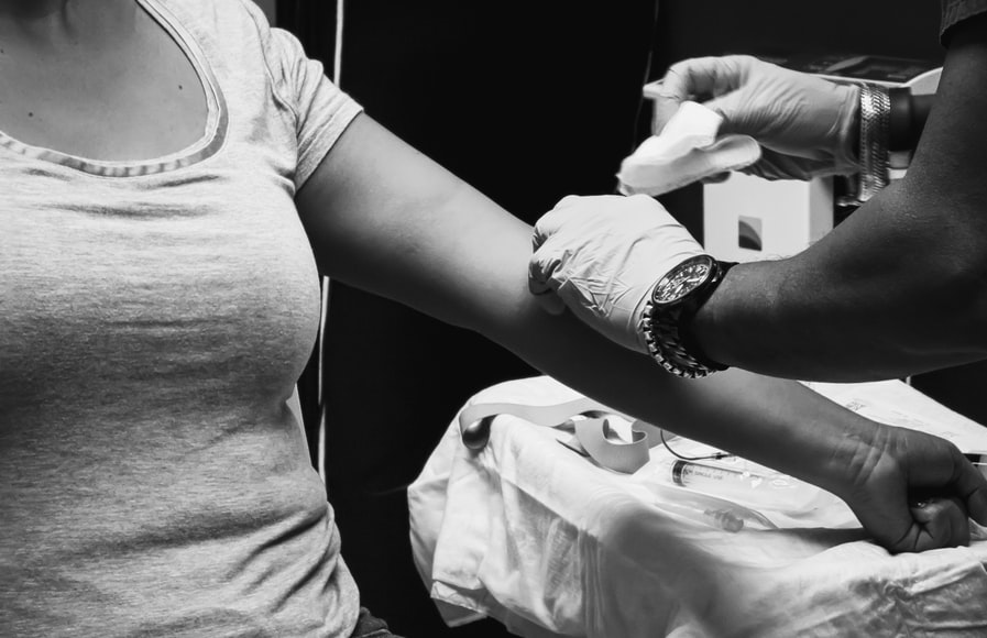 A person getting blood drawn for genetic testing.