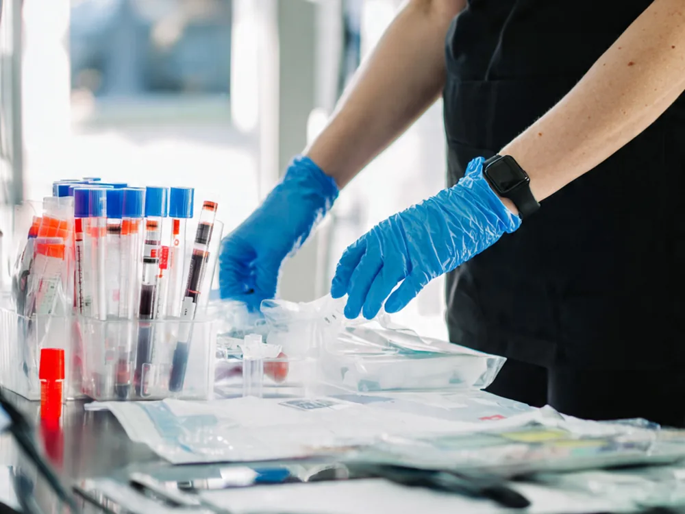 recurring home blood draws virginia, phlebotomist organizing specimen tubes for a standing order visit