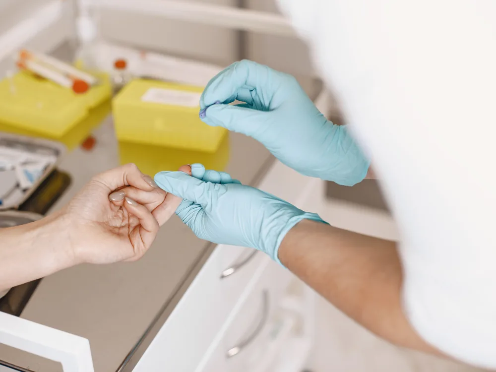 stat blood draw service in Virginia, certified technician performing a fingerstick collection