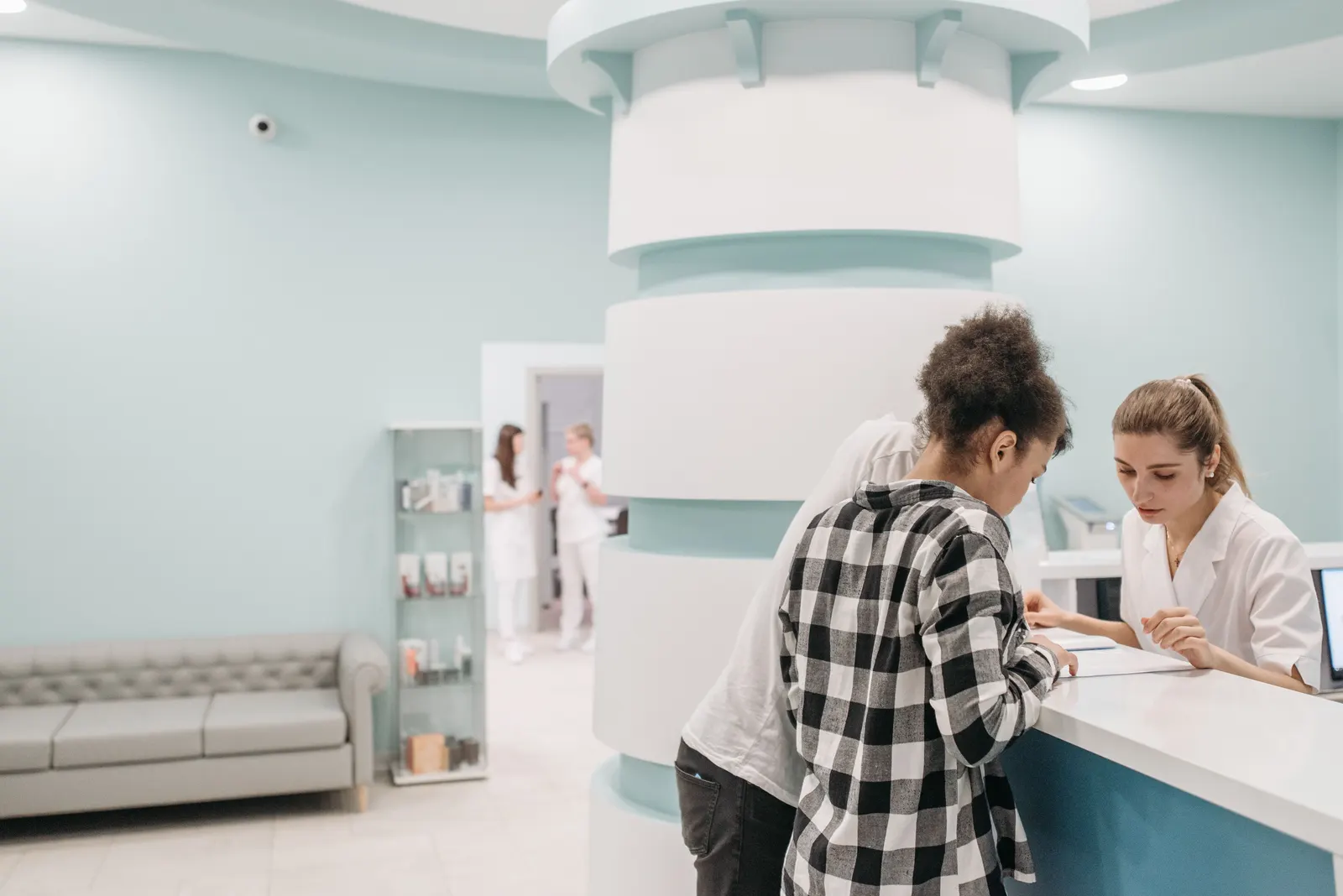 Patient checking in at a bright medical clinic reception desk